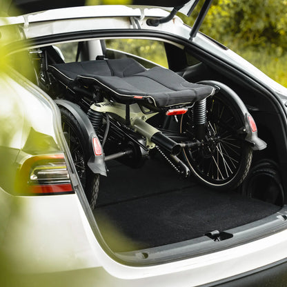 Closeup view of the Hase Kettwiesel One Plus Enviolo Bosch Performance CX Pale Green Recumbent Trike folded in a hatchback car.