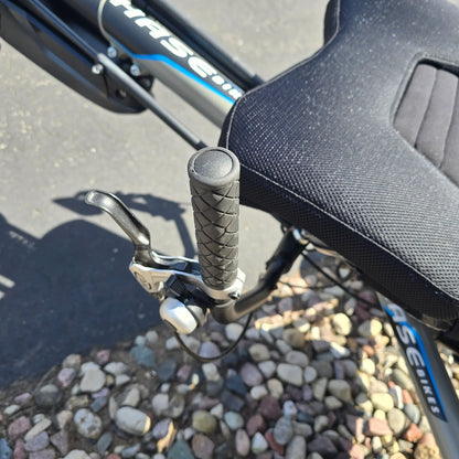 Closeup view of the handlebar and bell on the Hase Used 2022 Kettwiesel Evo Steps 6100 with 630wh Battery and 2A Charger Recumbent Trike in an outdoor setting.