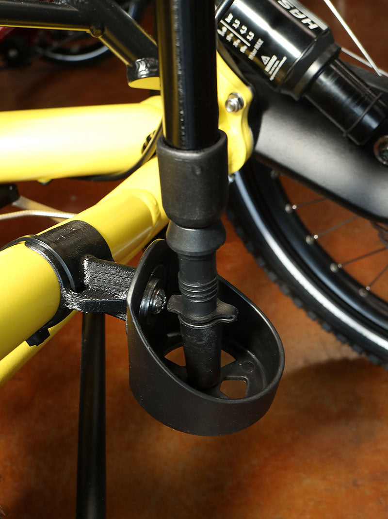 Image of the lower portion of a Hase Walking Stick Mount attached to a yellow recumbent trike. 