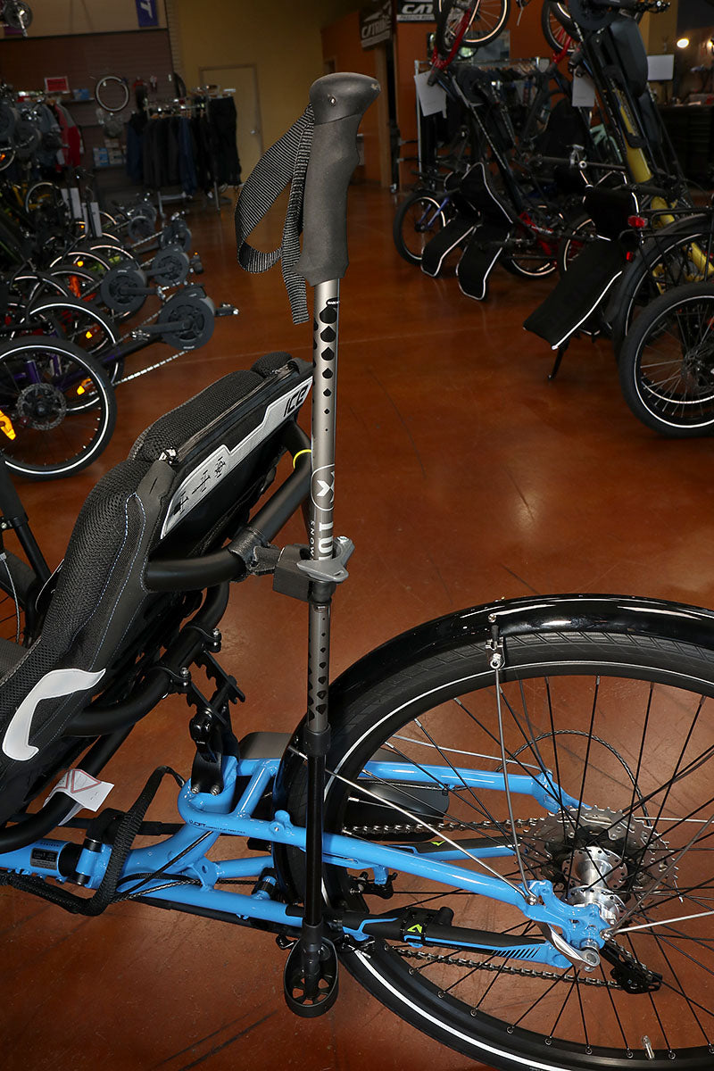 Image of a walking stick secured to a Hase Walking Stick Mount mounted on a blue recumbent trike. 