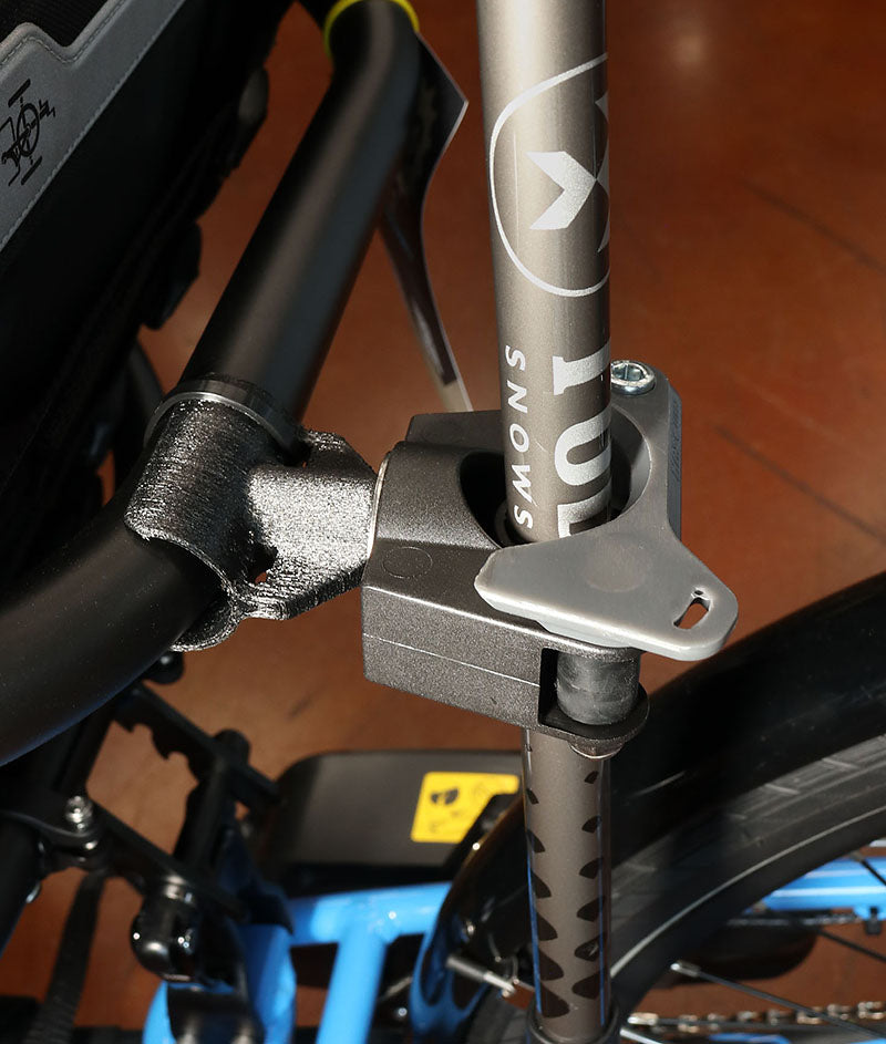 Image of a walking stick installed into the top portion of the Hase Walking Stick Mount attached to the back of a seat of a recumbent trike. 