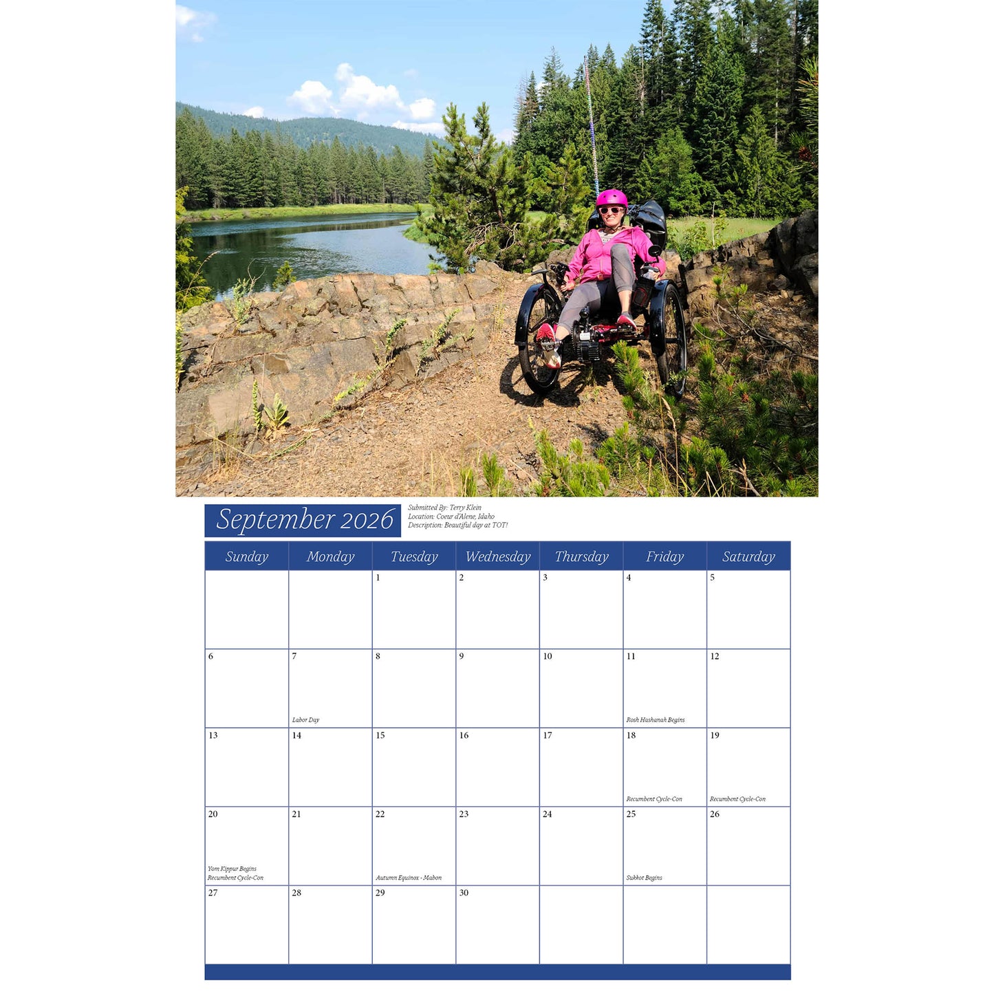 Calendar page for September 2026 showing a person on a recumbent trike by a lake with mountains.