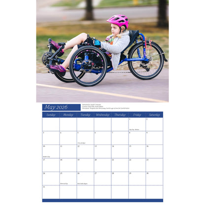 Calendar page for May 2026 showing a child on a tricycle with a helmet.