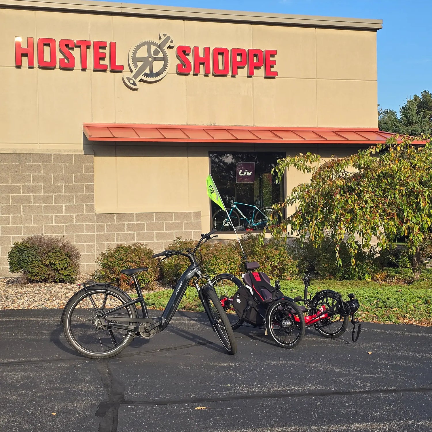 Image of a bike and trike in front of the Hostel Shoppe.