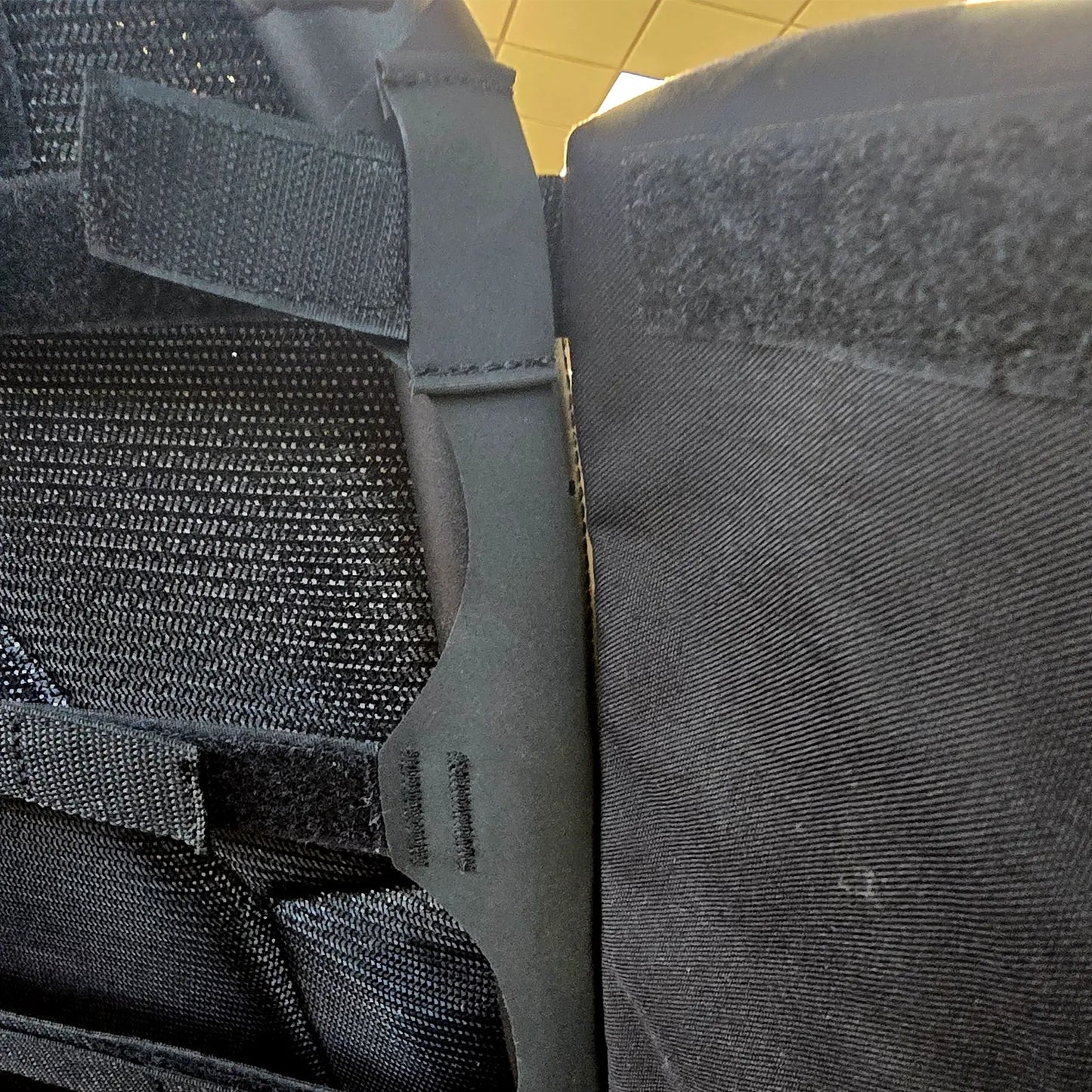 Closeup view of attachment loop and Velcro on the HP Velotechnik Add-On Bags for Mesh Seat in black mounted on a trike.