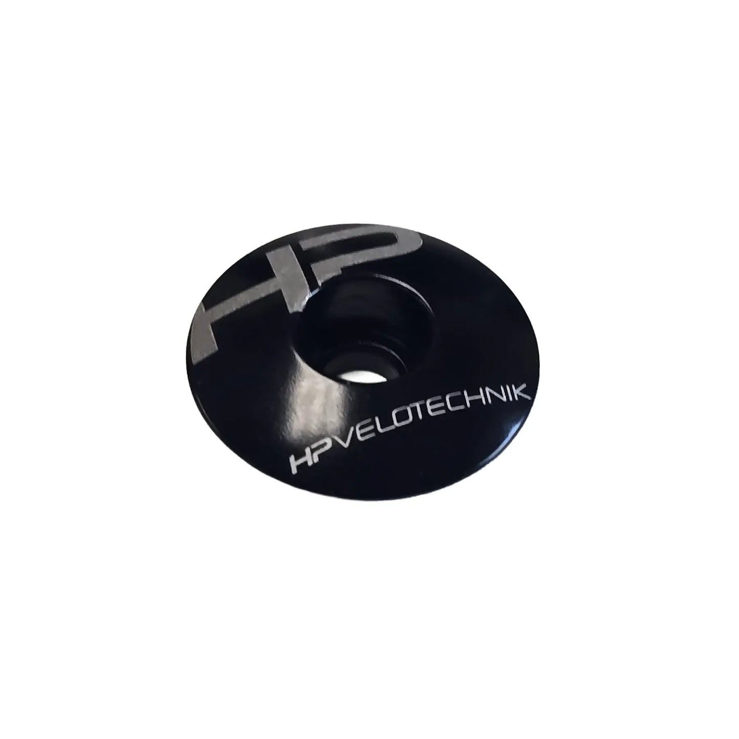Angled view of the HP Velotechnik Ahead Cap in black and silver against a white background.