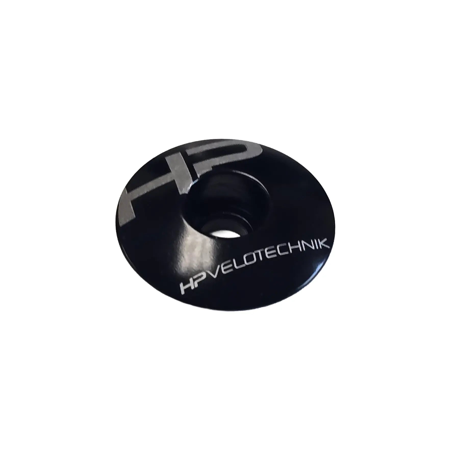 Angled view of the HP Velotechnik Ahead Cap in black and silver against a white background.