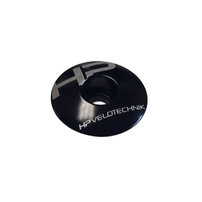 Angled view of the HP Velotechnik Ahead Cap in black and silver against a white background.