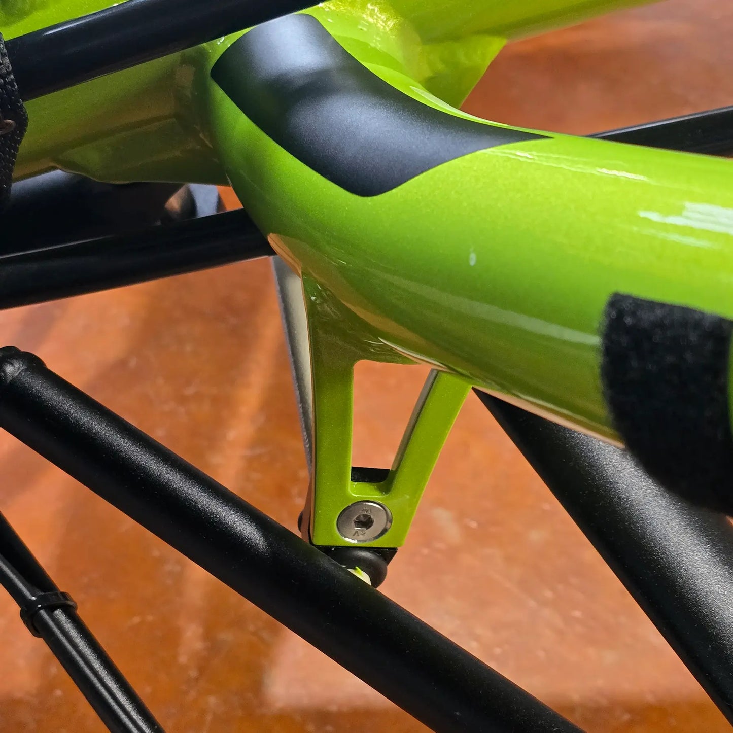 View of the HP Velotechnik Bolt for Front Suspension Stabilizer Bracket on a green front suspended trike.