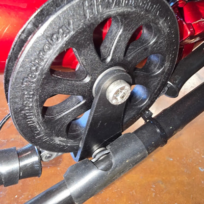 Head-on closeup view of the black metal HP Velotechnik Gekko Chain Catch Hook installed on a trike.