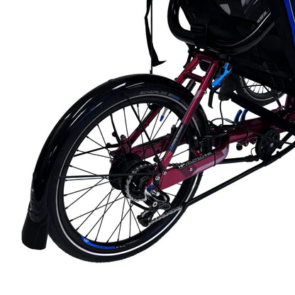 Closeup view of the rear wheel on the HP Velotechnik Gekko fxs Magma Red Recumbent Trike with Accessories against a white background.