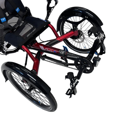 Closeup front view of the HP Velotechnik Gekko fxs Magma Red Recumbent Trike with Accessories against a white background.