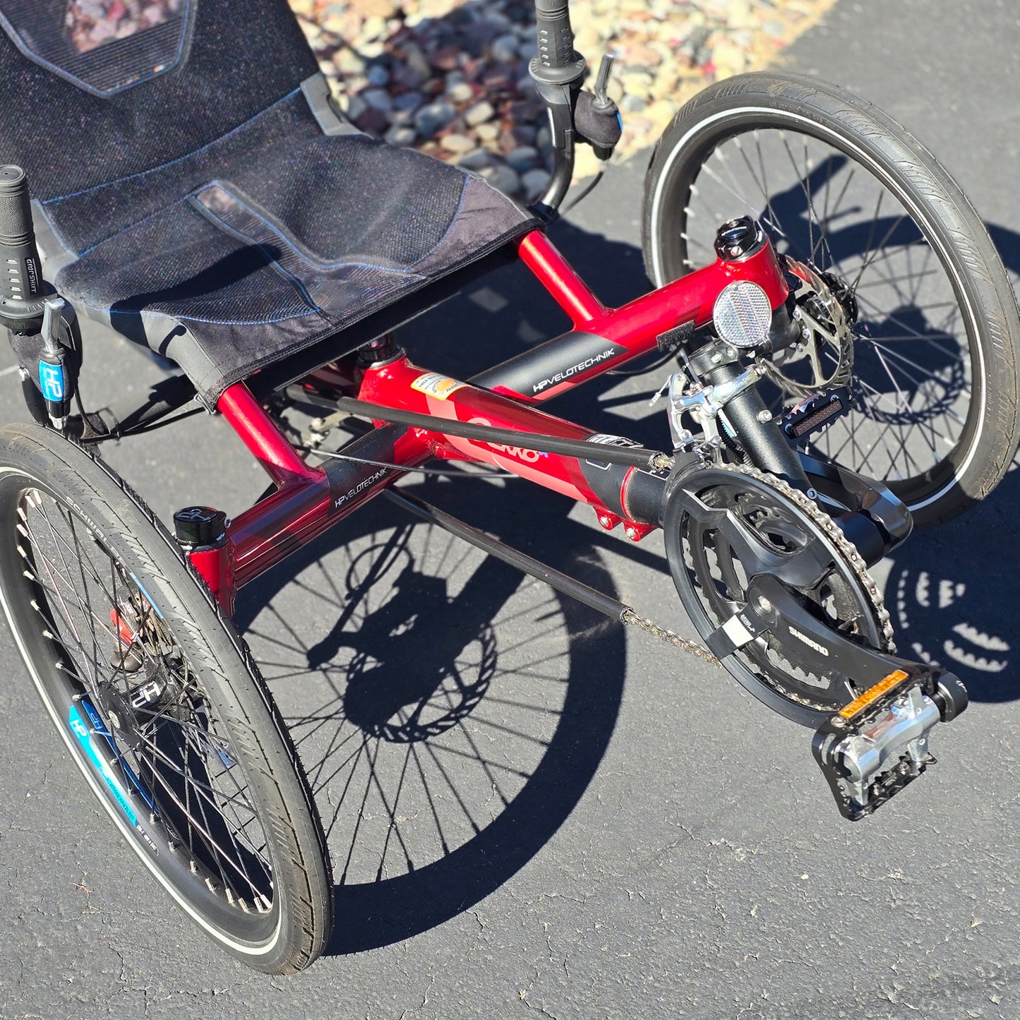 Front closeup view of the HP Velotechnik Used Gekko fx 20 Recumbent Trike in Magma Red in an outdoor setting.