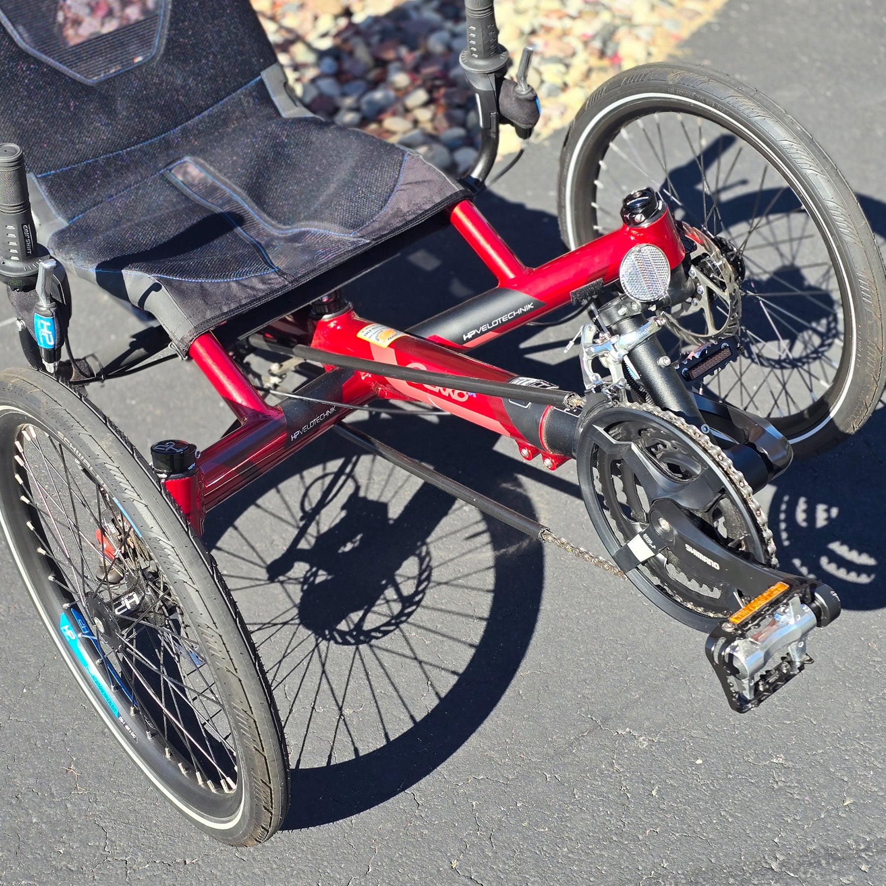 Front closeup view of the HP Velotechnik Used Gekko fx 20 Recumbent Trike in Magma Red in an outdoor setting.