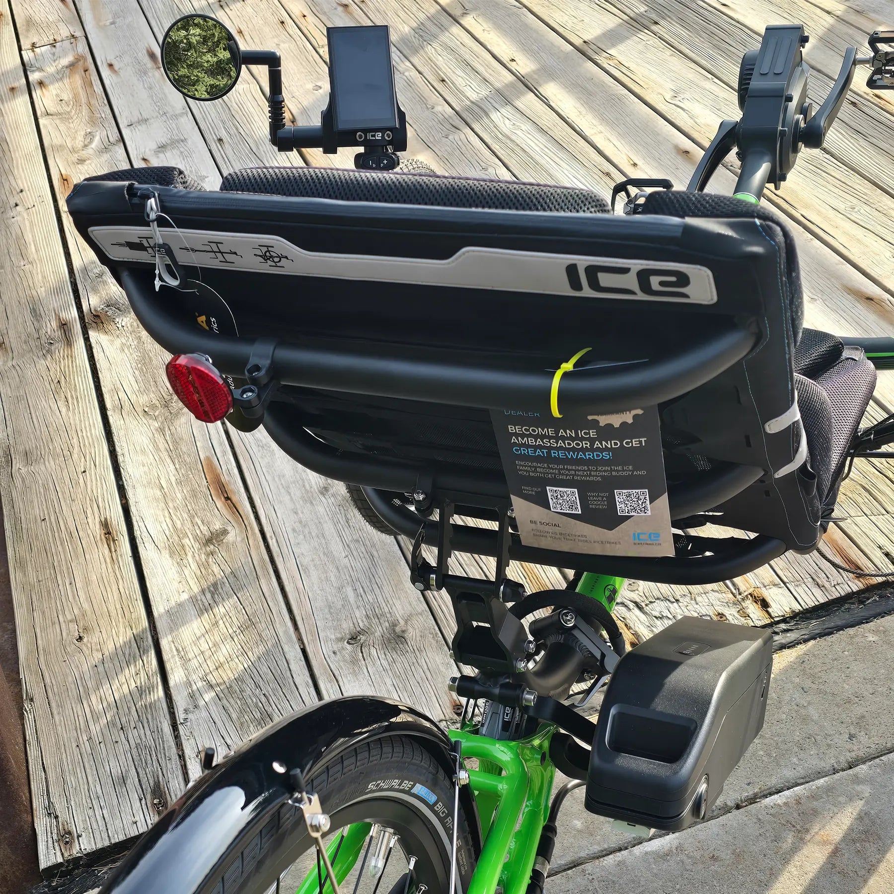 Closeup rear view of the ICE Adventure HD 26 FS PERS Chainless Kiwi Green Recumbent Trike on a bike path.