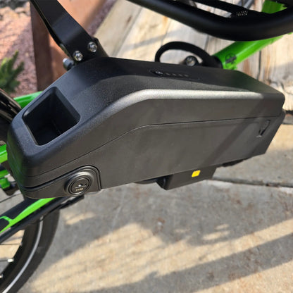 Closeup view of the battery on the ICE Adventure HD 26 FS PERS Chainless Kiwi Green Recumbent Trike on a bike path.