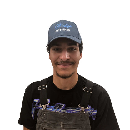 Front view of the ICE Trucker Cap in Petrol Blue with an embroidered trike in light blue and the words "ICE Trikes" in white on a model against a white background. 