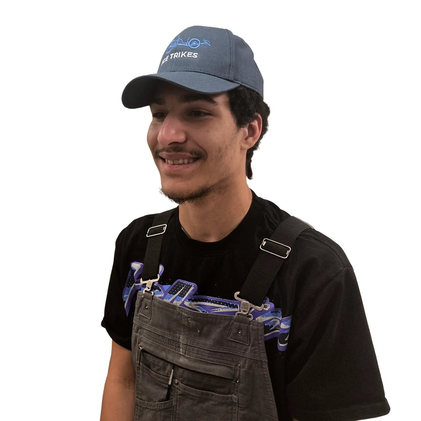 Side view of the ICE Trucker Cap in Petrol Blue with an embroidered trike in light blue and the words "ICE Trikes" in white on a model against a white background. 
