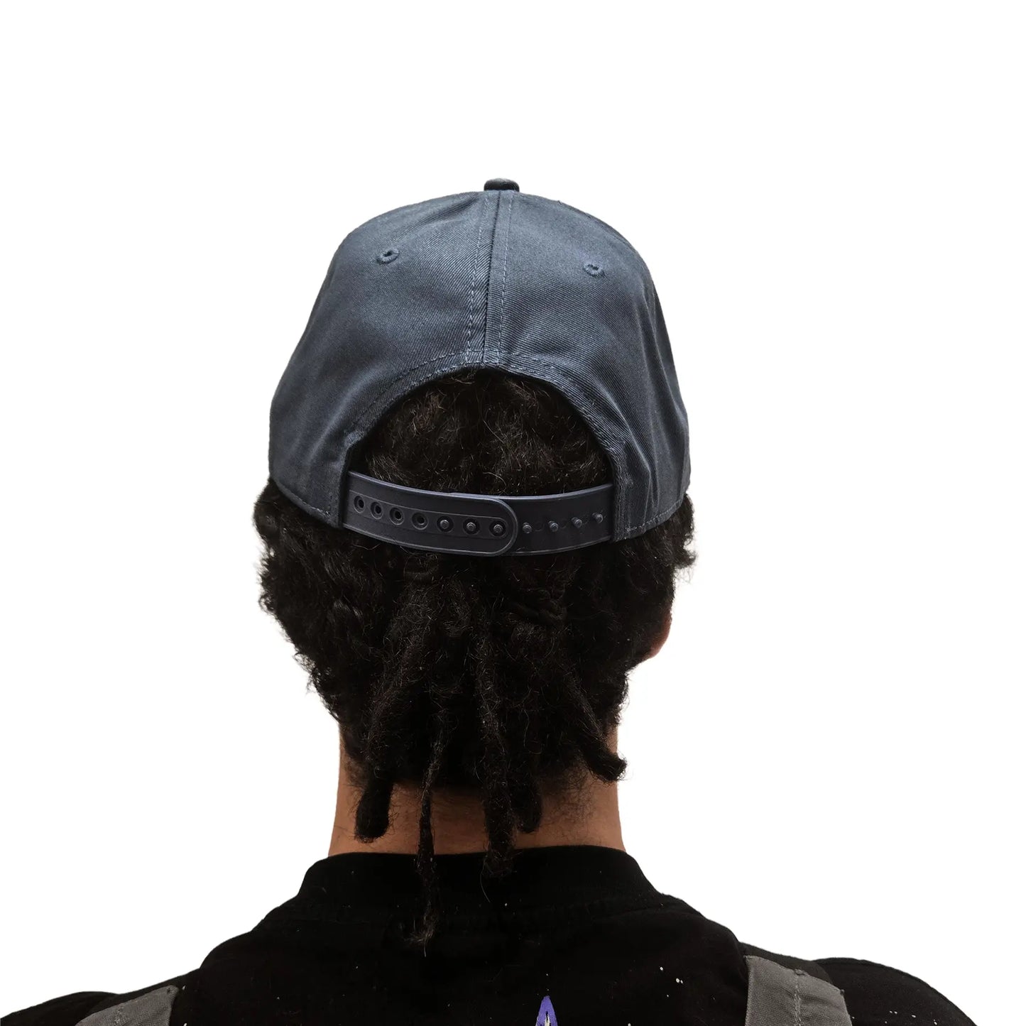 Rear view of the ICE Trucker Cap in Petrol Blue with an adjustable back on a model against a white background. 