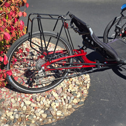 Rear Closeup view of the ICE Used Sprint 26 Red Recumbent Trike in an outdoor setting.