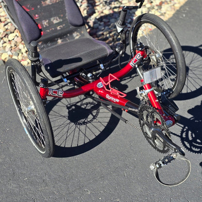 Front angled closeup view of the ICE Used Sprint 26 Red Recumbent Trike in an outdoor setting.