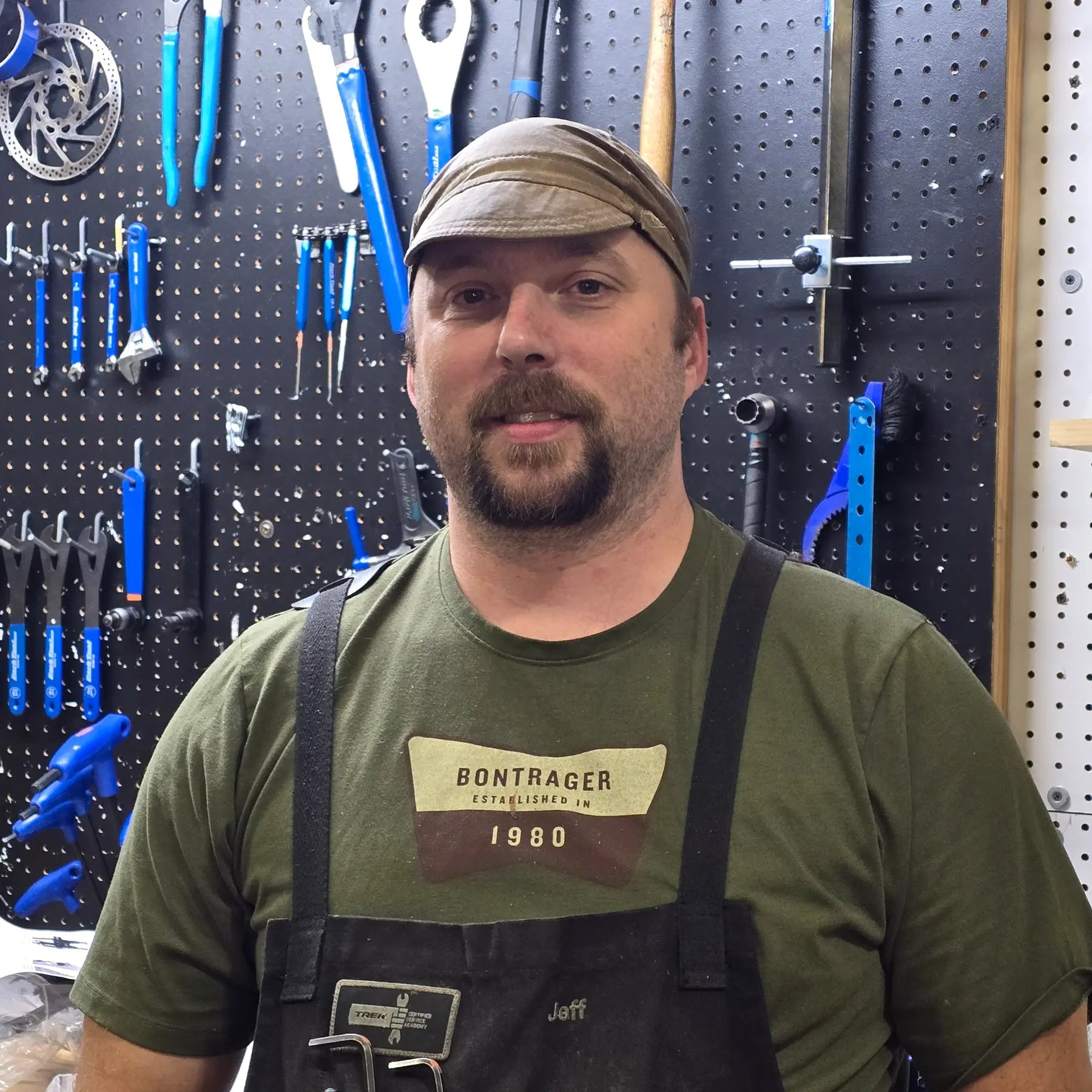 Jeff, Service Writer, in front of his work bench and tool board.