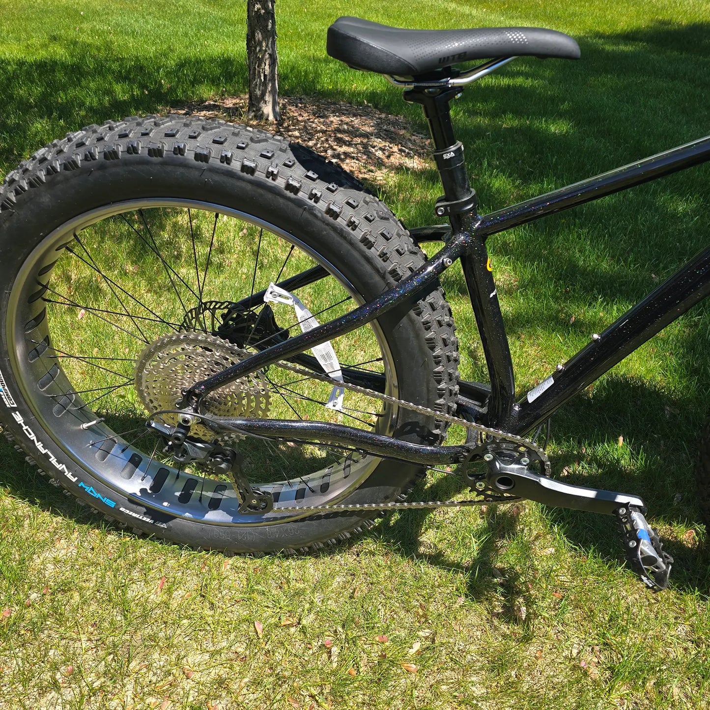 Rear side view of the KHS 4 Season 3000 Fat Bike with Carbon Fork in Black in an outdoor setting.