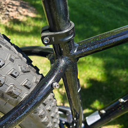 Closeup view of the frame on the KHS 4 Season 3000 Fat Bike with Carbon Fork in Black in an outdoor setting.