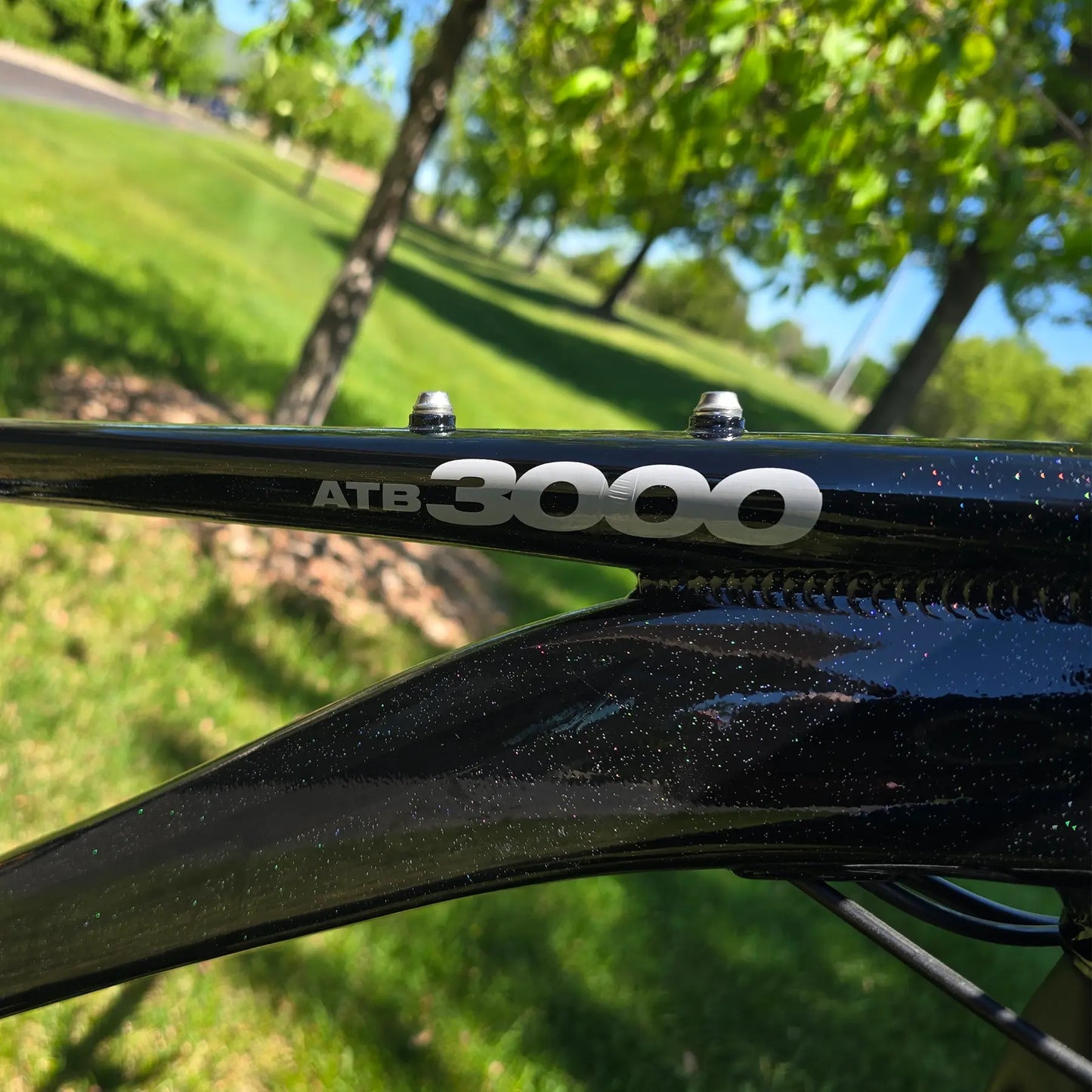 Closeup view of the frame on the KHS 4 Season 3000 Fat Bike with Carbon Fork in Black in an outdoor setting.