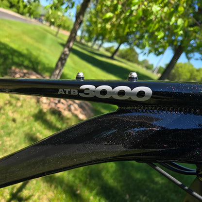 Closeup view of the frame on the KHS 4 Season 3000 Fat Bike with Carbon Fork in Black in an outdoor setting.
