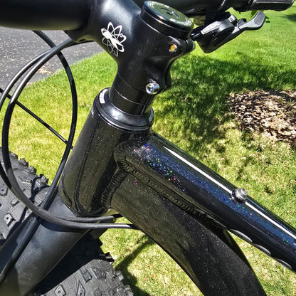 Closeup view of the frame and stem on the KHS 4 Season 3000 Fat Bike with Carbon Fork in Black in an outdoor setting.