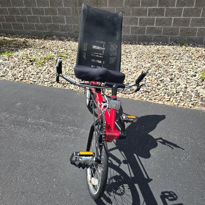 Front view of the Linear Used Red Recumbent Bike in an outdoor setting.
