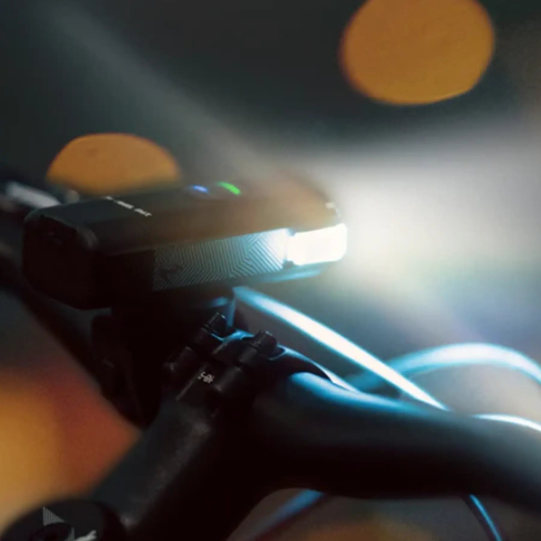 Closeup of the side light on the Moon Rigel Pro 1000 Lumen Headlight lighted up on a bike at night.