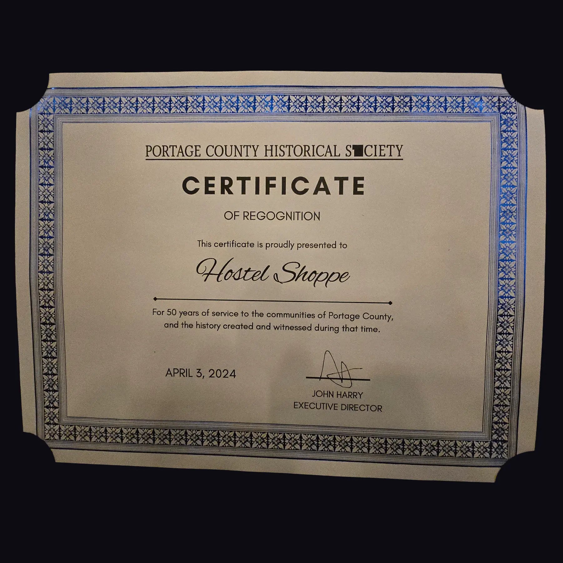 Portage County Historical Society Certificate of Recognition for Hostel Shoppe on a black background.