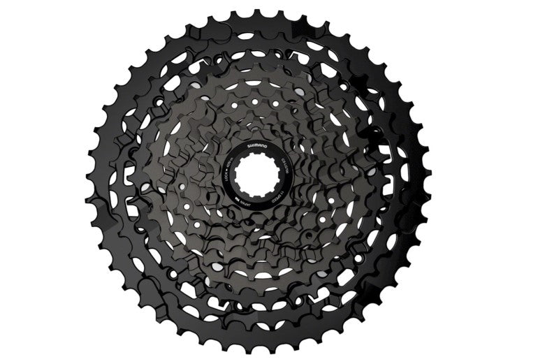 Top view of black Shimano CUES CS-LG700 cassette on white background. 