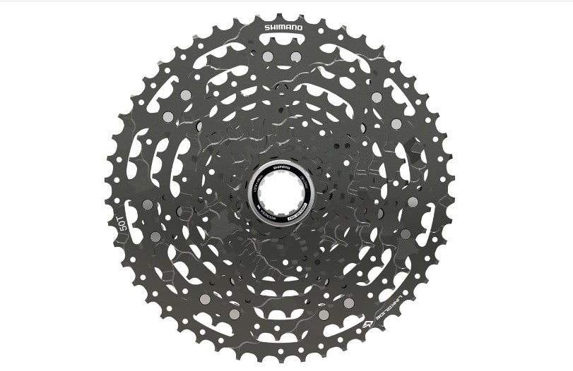 Top down view of black Shimano CUES CS-LG400 11 speed cassette on white background.