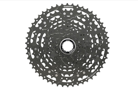 Top down view of black Shimano CUES CS-LG400 11 speed cassette on white background.