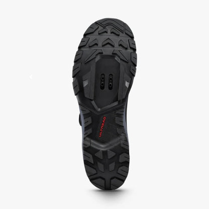 Bottom sole view of a Shimano SH-EX700 cycling shoe showing black tread and cut out for cleats. 