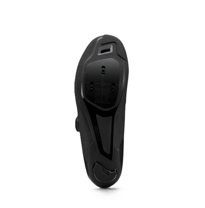 Bottom view of sole of black Shimano SH-RC302 cycling shoe on white background. 