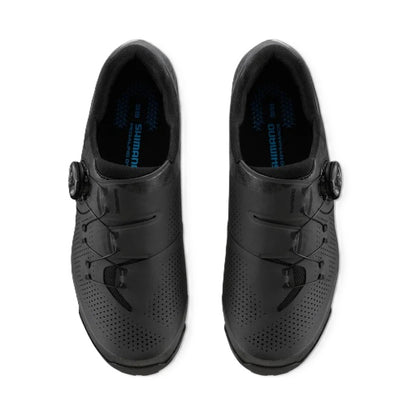 A pair of black Shimano SH-XC302 cycling shoes with Boa dial-up closures, shown from a top-down view on a white background.