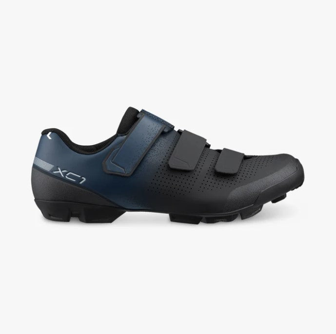 Navy and black Shimano SH-XC102W cycling show with three velcro straps and white XC1 lettering along heel.
