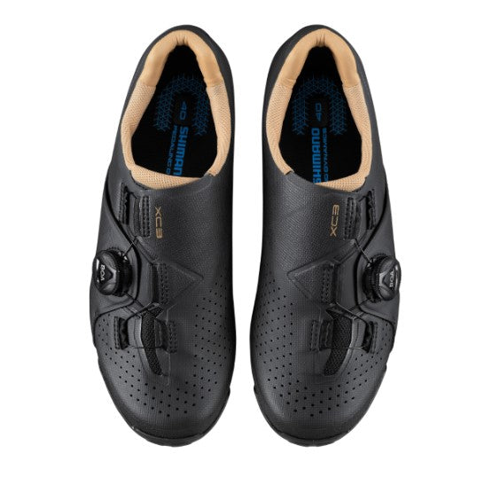 Pair of black Shimano XC300 cycling shoes with tan lining on a white background