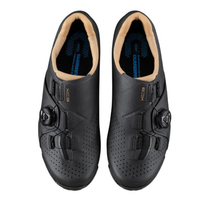 Pair of black Shimano XC300 cycling shoes with tan lining on a white background