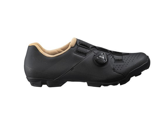 Black Shimano XC300 cycling shoe with beige lining on a white background
