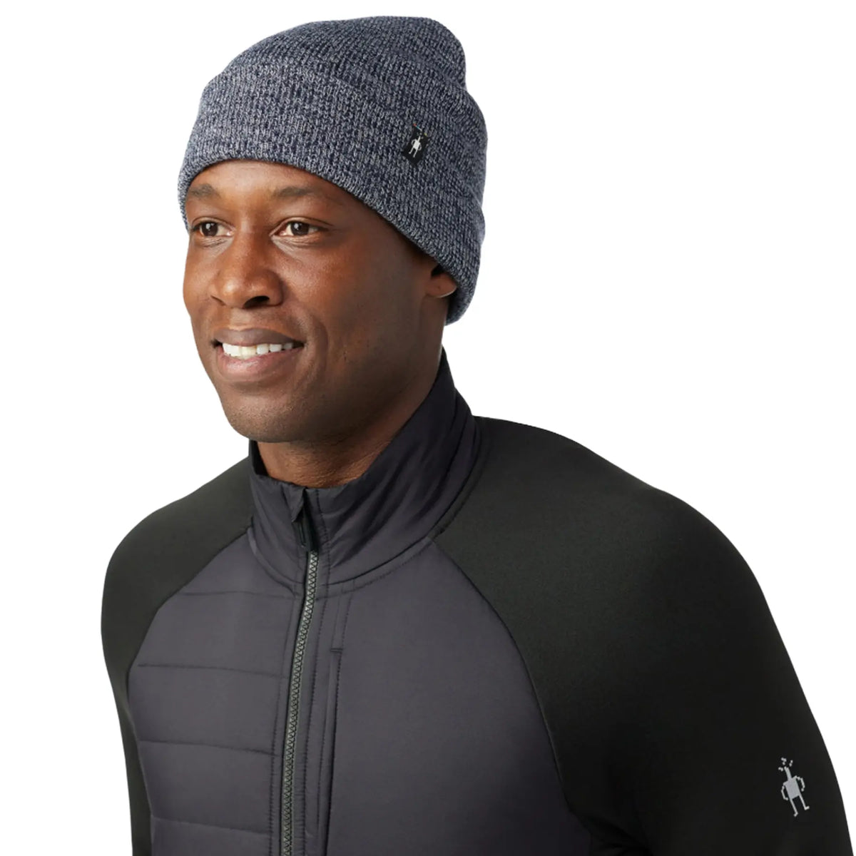 A man wearing a Smartwool Cozy Cabin Hat in deep navy against a white background.