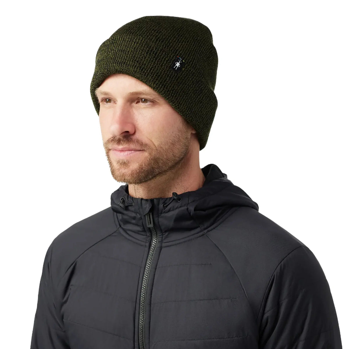 A man wearing a Smartwool Cozy Cabin Hat in winter moss against a white background.