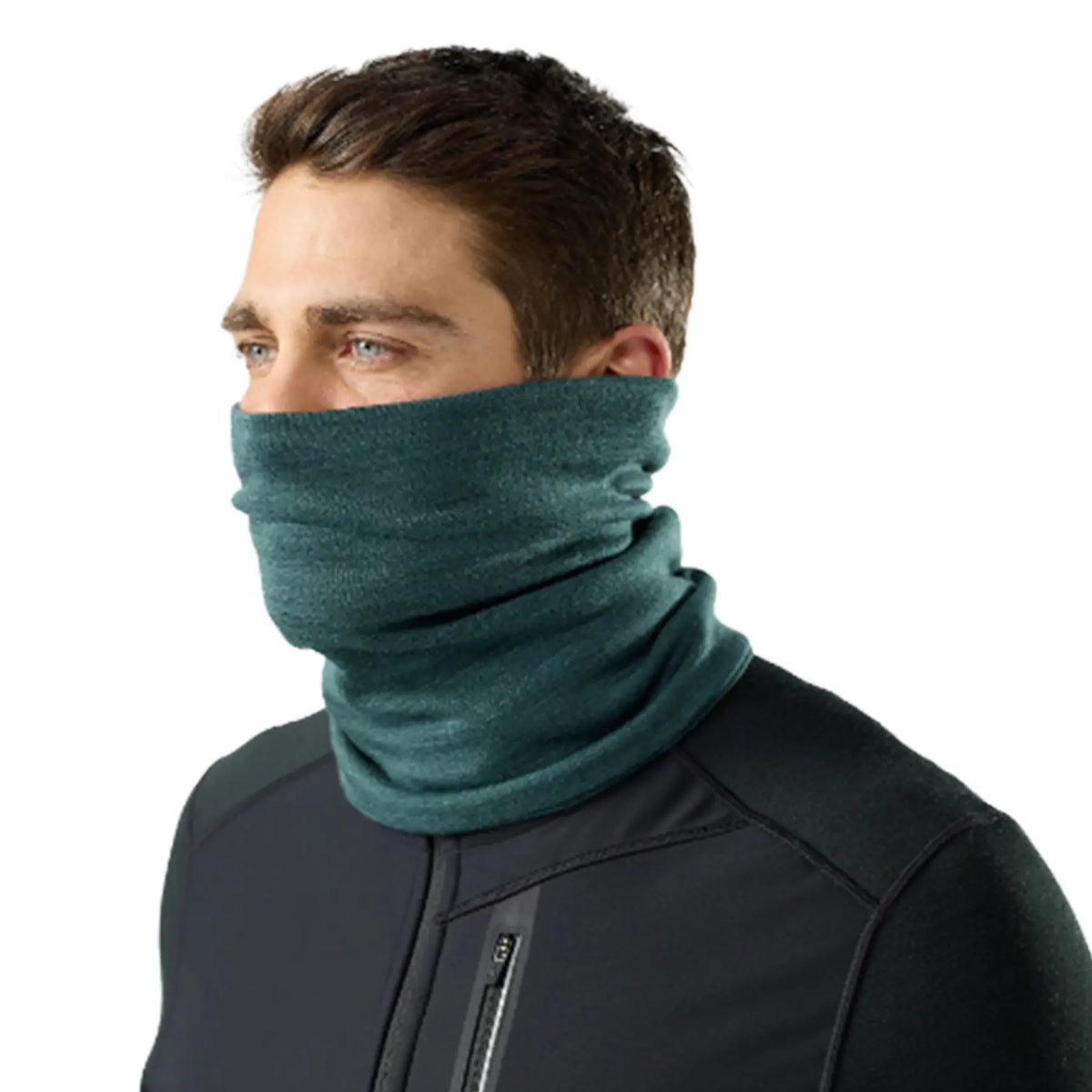 A man wearing a Smartwool Thermal Merino Reversible Neck Gaiter in Dark 
Teal Heather, paired with a black zippered athletic jacket, shown against a solid white background.