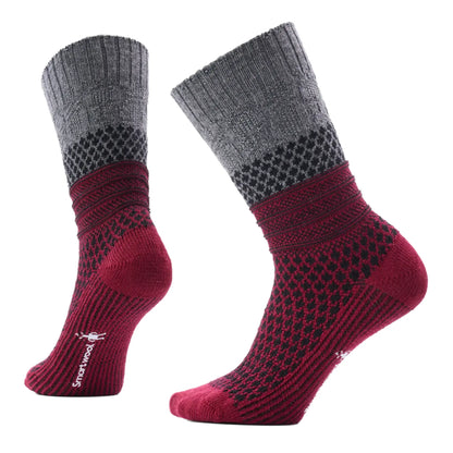 Side view of a pair of Smartwool Womens Everyday Popcorn Cable Socks in Black and Tibetan Red, a grey and dark red sock with a black pattern against a white background.