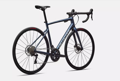 Back angled view of blue Specialized Allez e5 road bicycle on a white background.