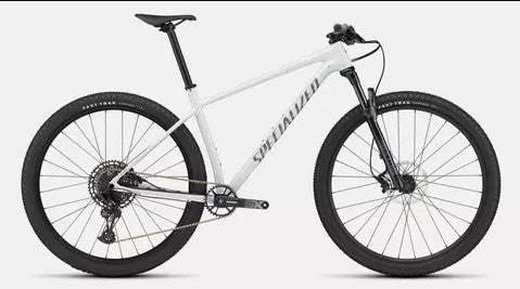 Right profile of white Specialized Chisel mountain bicycle with black tires on a white background